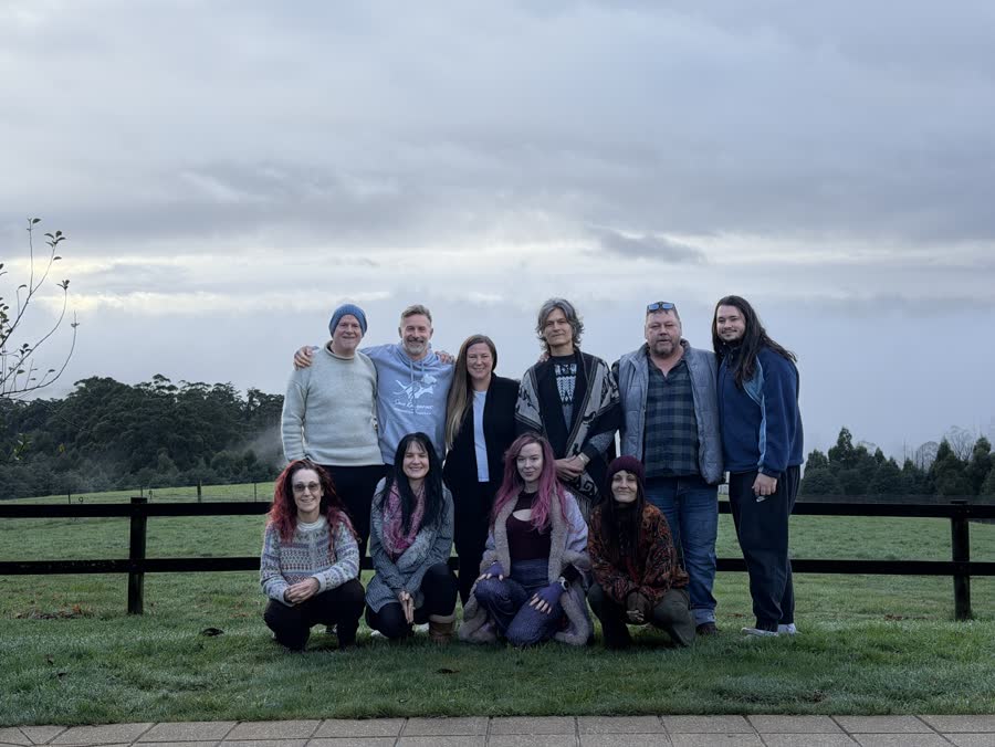 The CPACT cohort gathered together in a green field beneath open sky